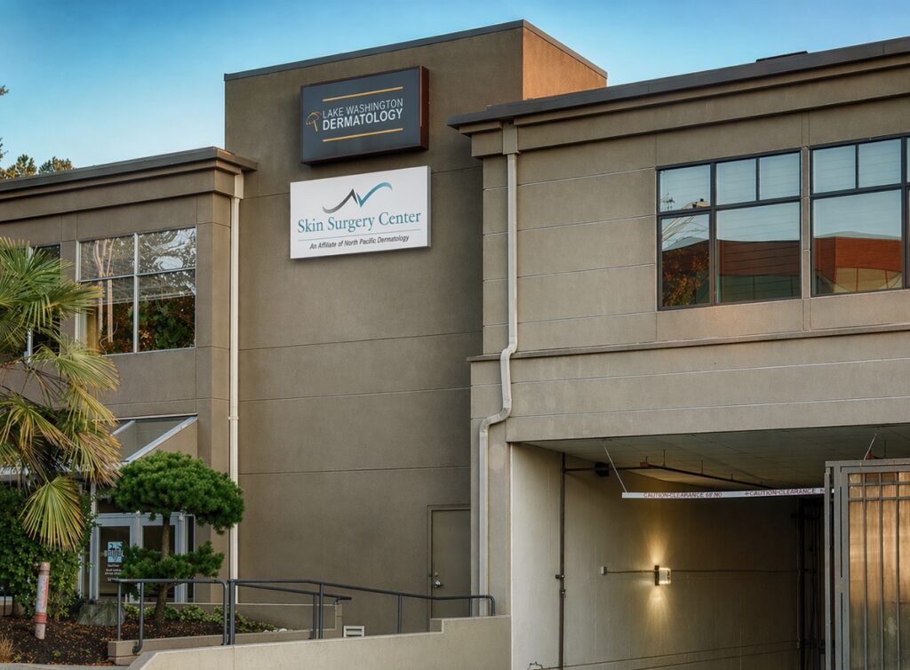 Exterior of a medical clinic building with signs for Lake Washington Dermatology and Skin Surgery Center.